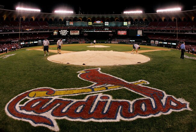 ST. LOUIS - OCTOBER 19:  Stadium workers cover home plate with a tarp as security keeps a close eye on fans remaining in the stands following the St. Louis Cardinals 5-1 loss the Houston Astros during Game Six of the National League Championship Series October 19, 2005 at Busch Stadium in St. Louis, Missouri. With the win the Astros won the series 4-2 and advanced to the World Series. The game was the last to be played in the 40 year history of Busch Stadium. A new Busch Stadium (under construction) will be the new home of the Cardinals starting with the opening of the 2006 MLB regular season. (Photo by Brian Bahr/Getty Images)