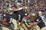 SOUTH BEND, IN - OCTOBER 29: (L-R) Theo Riddick #6, Taylor Dever #75, Michael Floyd #3 and Tyler Eifert #80 of the Notre Dame Fighting Irish celebrate Floyd's touchdown against the Navy Midshipmen at Notre Dame Stadium on October 29, 2011 in South Bend, Indiana. Notre Dame defeated Navy 56-14. (Photo by Jonathan Daniel/Getty Images)