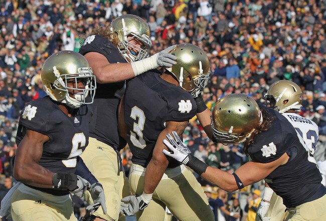 SOUTH BEND, IN - OCTOBER 29: (L-R) Theo Riddick #6, Taylor Dever #75, Michael Floyd #3 and Tyler Eifert #80 of the Notre Dame Fighting Irish celebrate Floyd's touchdown against the Navy Midshipmen at Notre Dame Stadium on October 29, 2011 in South Bend, Indiana. Notre Dame defeated Navy 56-14. (Photo by Jonathan Daniel/Getty Images)