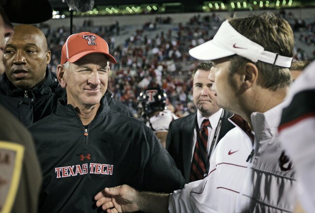 NORMAN, OK - OCTOBER 22:  Texas Tech Head Coach Tommy Tuberville and the Oklahoma Sooners Head Coach Bob Stoops meet after the game October 22, 2011 at Gaylord Family-Oklahoma Memorial Stadium in Norman, Oklahoma. Texas Tech upset Oklahoma 41-38. (Photo by Brett Deering/Getty Images)