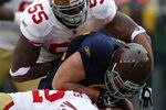 GREEN BAY, WI - DECEMBER 05: Ahmad Brooks #55 and Nate Clements #22 of the San Francisco 49ers tackle John Kuhn #30 of the Green Bay Packers at Lambeau Field on December 5, 2010 in Green Bay, Wisconsin. The Packers defeated the 49ers 34-16.  (Photo by Jonathan Daniel/Getty Images)
