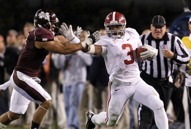 STARKVILLE, MS - NOVEMBER 12:  Running back Trent Richardson #3 of the Alabama Crimson Tide stiff arms defensive back Wade Bonner #7 of the Mississippi State Bulldogs during a big first down run in the fourth quarter on November 12, 2011 at Davis Wade Stadium in Starkville, Mississippi. (Photo by Butch Dill/Getty Images)