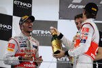 ABU DHABI, UNITED ARAB EMIRATES - NOVEMBER 13:  Race winner Lewis Hamilton (L) of Great Britain and McLaren celebrates on the podium with third placed Jenson Button (R) of Great Britain and McLaren following the Abu Dhabi Formula One Grand Prix at the Yas Marina Circuit on November 13, 2011 in Abu Dhabi, United Arab Emirates.  (Photo by Mark Thompson/Getty Images)