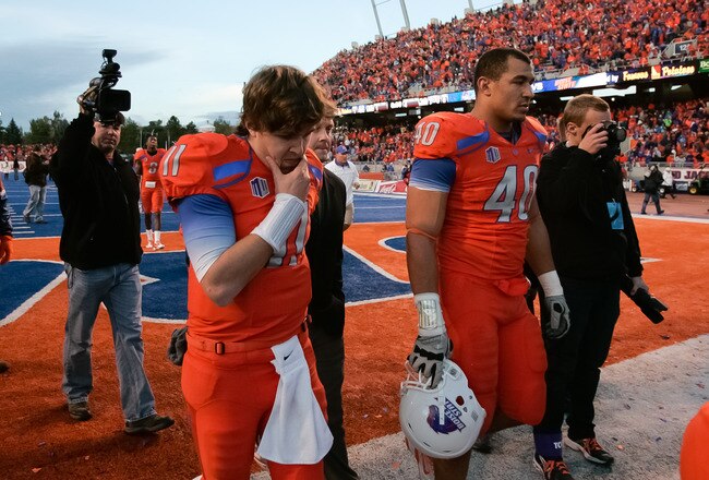 BOISE, ID - NOVEMBER 12:  Kellen Moore #11 and Tyrone Crawford #40 of the Boise State Broncos leave after the loss to the TCU Horned Frogs  at Bronco Stadium on November 12, 2011 in Boise, Idaho.  (Photo by Otto Kitsinger III/Getty Images)