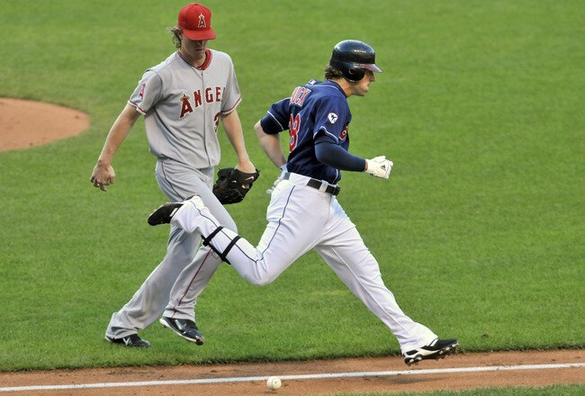 CLEVELAND, OH - JULY 26: Starting pitcher Jered Weaver #36 of the Los Angeles Angels and Travis Buck #28 of the Cleveland Indians nearly collide as Buck's ground ball rolls foul during the third inning at Progressive Field on July 26, 2011 in Cleveland, Ohio. The Indians defeated the Angels 3-2. (Photo by Jason Miller/Getty Images)