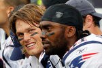 FOXBORO, MA - SEPTEMBER 12: Quarterback Tom Brady #12 and Randy Moss #81 of the New England Patriots take a breather on the bench during the NFL season opener against the Cincinnati Bengals at Gillette Stadium on September 12, 2010 in Foxboro, Massachusetts. (Photo by Jim Rogash/Getty Images)