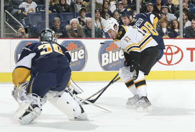 BUFFALO, NY - DECEMBER 10: Ryan Miller #30 of the Buffalo Sabres deflects the puck away from Milan Lucic #17 of the Boston Bruins as Nathan Paetsch #38 of the Sabres shadows Lucic at HSBC Arena December 10, 2007 in Buffalo, New York.  (Photo by Rick Stewart/Getty Images)