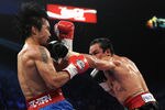 LAS VEGAS, NV - NOVEMBER 12:  (R-L) Juan Manuel Marquez throws a left to the face of Manny Pacquiao during the WBO world welterweight title fight at the MGM Grand Garden Arena on November 12, 2011 in Las Vegas, Nevada.  (Photo by Harry How/Getty Images)