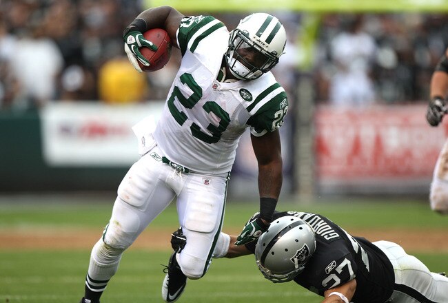OAKLAND, CA - SEPTEMBER 25:  Shonn Greene #23 of the New York Jets runs against Chris Johnson #37 of the Oakland Raiders at O.co Coliseum on September 25, 2011 in Oakland, California.  (Photo by Jed Jacobsohn/Getty Images)