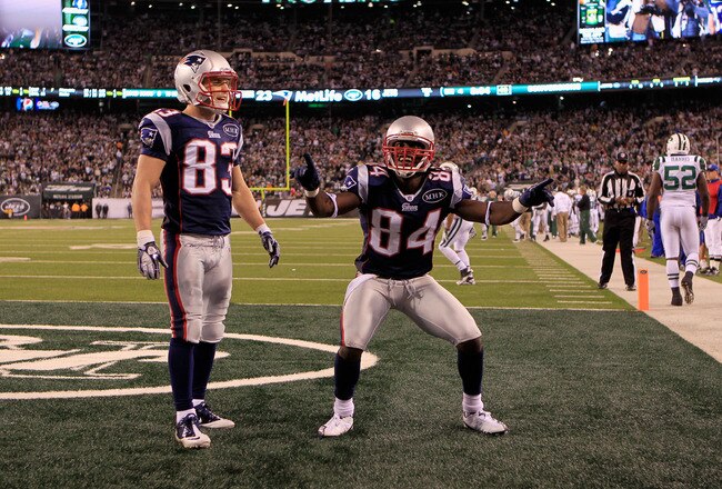 EAST RUTHERFORD, NJ - NOVEMBER 13:   Deion Branch #84 and Wes Welker #83 of the New England Patriots celebrate after a touchdown against the New York Jets at MetLife Stadium on November 13, 2011 in East Rutherford, New Jersey.  (Photo by Chris Trotman/Getty Images)