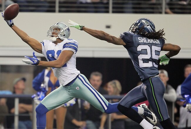 ARLINGTON, TX - NOVEMBER 06:  Wide receiver Laurent Robinson #81 of the Dallas Cowboys lunges but can't make a catch while being pursued by Richard Sherman #25 of the Seattle Seahawks in the second half at Cowboys Stadium on November 6, 2011 in Arlington, Texas. The Cowboys defeated the Seahawks 23-13.  (Photo by Jeff Gross/Getty Images)