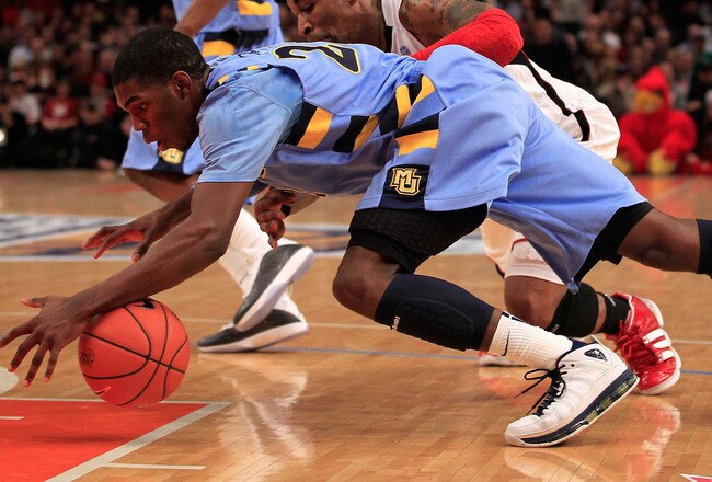 NEW YORK, NY - MARCH 10: Jamail Jones #22 of the Marquette Golden Eagles and Chris Smith #5 of the Louisville Cardinals dive for a lose ball during the quarterfinals of the 2011 Big East Men's Basketball Tournament presented by American Eagle Outfitters  at Madison Square Garden on March 10, 2011 in New York City.  (Photo by Chris Trotman/Getty Images)