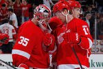 DETROIT, MI - NOVEMBER 08:  Jimmy Howard #35 of the Detroit Red Wings celebrates a 5-2 win over the Colorado Avalanche with Daniel Cleary #11 at Joe Louis Arena on November 8, 2011 in Detroit, Michigan. (Photo by Gregory Shamus/Getty Images)