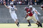 CAMBRIDGE, MA - NOVEMBER 20:  Patick Witt #11 of the Yale Bulldogs passes the ball as Victor Ojukwu #91 of the Harvard Crimson pressures on November 20, 2010 at Harvard Stadium in Cambridge, Massachusetts.  Harvard defeated Yale 28-21.  (Photo by Elsa/Getty Images)