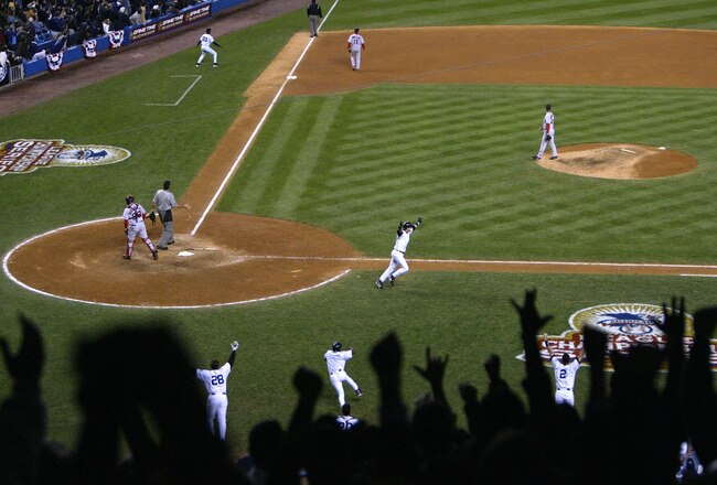 BRONX, NY - OCTOBER 16:  Aaron Boone #19 of the New York Yankees hits the game winning home run in the bottom of the eleventh inning against the Boston Red Sox during game 7 of the American League Championship Series on October 16, 2003 at Yankee Stadium in the Bronx, New York.  (Photo by Doug Pensinger/Getty Images)