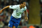 LONDON, ENGLAND - OCTOBER 12:  Milorad Pekovic of Montenegro and Rio Ferdinand of England in action during the UEFA EURO 2012 Group G Qualifying match between England and Montenegro at Wembley Stadium on October 12, 2010 in London, England.  (Photo by Mike Hewitt/Getty Images)