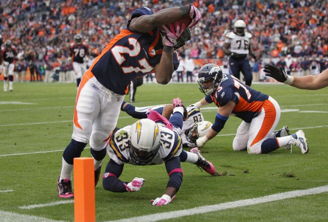 DENVER, CO - OCTOBER 09:  Running back Knowshon Moreno #27 of the Denver Broncos dives over Dante Hughes #33 of the San Diego Chargers for a touchdown at Sports Authority Field at Mile High on October 9, 2011 in Denver, Colorado. The Chargers defeated the Broncos 29-24.  (Photo by Doug Pensinger/Getty Images)