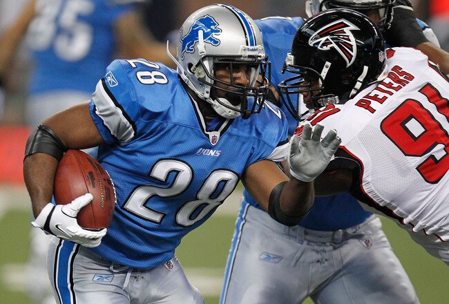 DETROIT, MI - OCTOBER 23:  Maurice Morris #28 of the Detroit Lions tries to get around the tackle of  Corey Peters #91 of the Atlanta Falcons during a first quarter run at Ford Field on October 23, 2011 in Detroit, Michigan.  (Photo by Gregory Shamus/Getty Images)