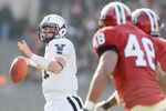 CAMBRIDGE, MA - NOVEMBER 20:  Patrick Witt #11 of the Yale Bulldogs looks to pass as Josue Ortiz of the Harvard Crimson defends on November 20, 2010 at Harvard Stadium in Cambridge, Massachusetts.  Harvard defeated Yale 28-21.  (Photo by Elsa/Getty Images)