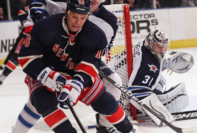 NEW YORK, NY - NOVEMBER 06: Jim Slater #19 of the Winnipeg Jets checks Sean Avery #16 of the New York Rangers at Madison Square Garden on November 6, 2011 in New York City. The Rangers defeated the Jets 3-0. (Photo by Bruce Bennett/Getty Images)