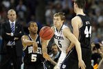 HOUSTON, TX - APRIL 04:  Ronald Nored #5 of the Butler Bulldogs passes the ball against Niels Giffey #5 of the Connecticut Huskies during the National Championship Game of the 2011 NCAA Division I Men's Basketball Tournament at Reliant Stadium on April 4, 2011 in Houston, Texas.  (Photo by Ronald Martinez/Getty Images)