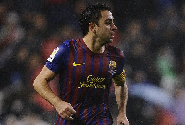 BILBAO, SPAIN - NOVEMBER 06:  Xavi Hernandez of FC Barcelona runs with the ball during the La Liga match between Athletic Club and FC Barcelona at San Mames Stadium on November 6, 2011 in Bilbao, Spain.  (Photo by David Ramos/Getty Images)