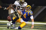ST. LOUIS, MO - OCTOBER 30: A.J. Feeley #4 of the St. Louis Rams fumbles the ball after being sacked by Malcolm Jenkins #27 of the New Orleans Saints at the Edward Jones Dome on October 30, 2011 in St. Louis, Missouri.  The Rams beat the Saints 31-21.  (Photo by Dilip Vishwanat/Getty Images)