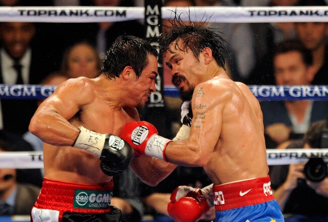LAS VEGAS, NV - NOVEMBER 12:  Juan Manuel Marquez (L) and Manny Pacquiao battle in the 10th round of their WBO world welterweight title fight at the MGM Grand Garden Arena November 12, 2011 in Las Vegas, Nevada. Pacquiao retained his title with a majority decision victory.  (Photo by Ethan Miller/Getty Images)