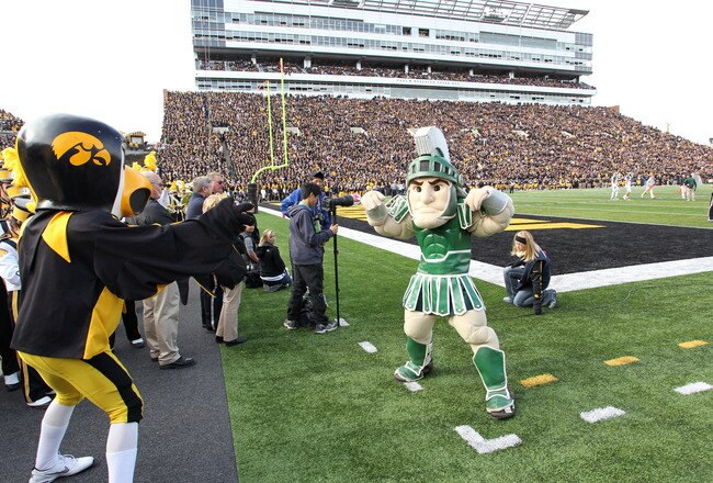 IOWA CITY, IA - NOVEMBER 12:  Herky the mascot of the Iowa Hawkeyes battles with Sparty of the Michigan State Spartans before kickoff at Kinnick Stadium November 12, 2011 in Iowa City, Iowa. Michigan State beat Iowa 37-21.  (Photo by Reese Strickland/Getty Images)