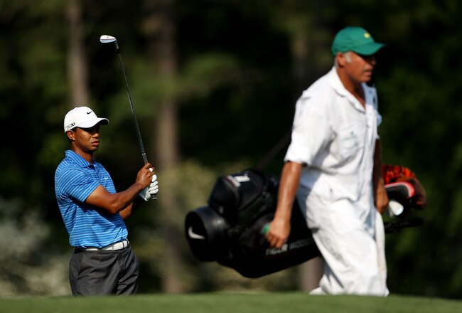 AUGUSTA, GA - APRIL 09:  Tiger Woods watches his shot as caddie Steve Williams walks by during the third round of the 2011 Masters Tournament at Augusta National Golf Club on April 9, 2011 in Augusta, Georgia.  (Photo by Andrew Redington/Getty Images)
