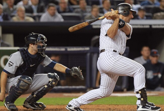 NEW YORK, NY - OCTOBER 06:  Jorge Posada #20 of the New York Yankees hits a single in the bottom of the sixth inning against the Detroit Tigers during Game Five of the American League Championship Series at Yankee Stadium on October 6, 2011 in the Bronx borough of New York City.  (Photo by Nick Laham/Getty Images)