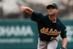 ANAHEIM, CA - SEPTEMBER 25:  Rich Harden #18 of the Oakland Athletics pitches against the Los Angeles Angels of Anaheim in the first inning at Angel Stadium of Anaheim on September 25, 2011 in Anaheim, California.  (Photo by Jeff Golden/Getty Images)