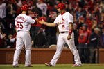 ST LOUIS, MO - OCTOBER 28: Albert Pujols #5 (R) of the St. Louis Cardinals is congratulated by Skip Schumaker #55 after scoring after Rafael Furcal #15 was hit by a pitch with the bases loaded in the fifth inning during Game Seven of the MLB World Series at Busch Stadium on October 28, 2011 in St Louis, Missouri.  (Photo by Jamie Squire/Getty Images)