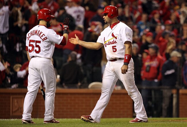 ST LOUIS, MO - OCTOBER 28: Albert Pujols #5 (R) of the St. Louis Cardinals is congratulated by Skip Schumaker #55 after scoring after Rafael Furcal #15 was hit by a pitch with the bases loaded in the fifth inning during Game Seven of the MLB World Series at Busch Stadium on October 28, 2011 in St Louis, Missouri.  (Photo by Jamie Squire/Getty Images)
