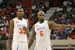 OKLAHOMA CITY, OK - OCTOBER 23:  Kevin Durant  and LeBron James of Team White talk during a timeout at the US Fleet Tracking Basketball Invitational charity basketball game October 23, 2011 at the Cox Convention Center in Oklahoma City, Oklahoma.  The game benefitted the Single Parents Support Network of Oklahoma City .  (Photo by Brett Deering/Getty Images)