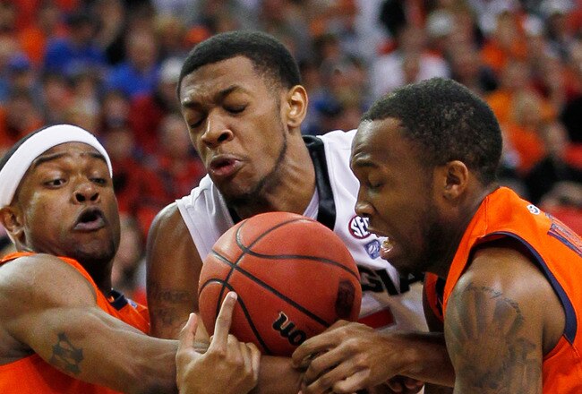 ATLANTA, GA - MARCH 10:  Donte Williams #15 of the Georgia Bulldogs vies for posession of the ball with Kenny Gabriel #22 and Josh Wallace #11 of the Auburn Tigers during the first round of the SEC Men's Basketball Tournament at the Georgia Dome on March 10, 2011 in Atlanta, Georgia.  (Photo by Kevin C. Cox/Getty Images)