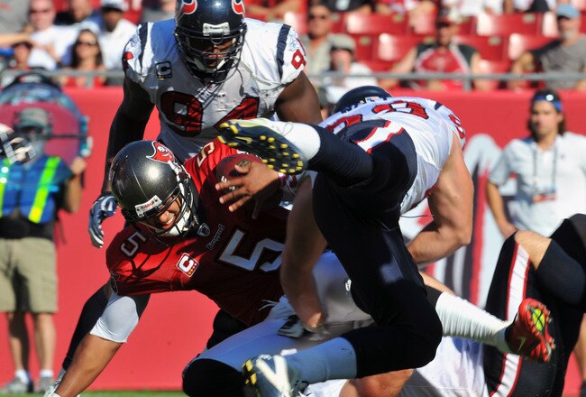 TAMPA, FL - NOVEMBER 13:  Defensive end J. J. Watt #99 of the Houston Texans sacks quarterback Josh Freeman #5 of the Tampa Bay Buccaneers November 13, 2011 at Raymond James Stadium in Tampa, Florida. (Photo by Al Messerschmidt/Getty Images)