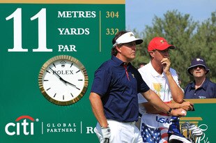 MELBOURNE, AUSTRALIA - NOVEMBER 17: Phil Mickelson of the U.S. Team and caddie Jim 'Bones' Mackay stand on the 11th tee during the Day One Foursome Matches of the 2011 Presidents Cup at Royal Melbourne Golf Course on November 17, 2011 in Melbourne, Australia.  (Photo by Scott Halleran/Getty Images)
