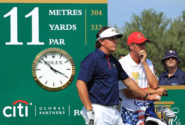 MELBOURNE, AUSTRALIA - NOVEMBER 17: Phil Mickelson of the U.S. Team and caddie Jim 'Bones' Mackay stand on the 11th tee during the Day One Foursome Matches of the 2011 Presidents Cup at Royal Melbourne Golf Course on November 17, 2011 in Melbourne, Australia.  (Photo by Scott Halleran/Getty Images)