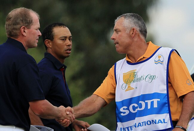 MELBOURNE, AUSTRALIA - NOVEMBER 17: Steve Stricker of the U.S. Team (L) shakes hands with caddie Steve Williams (R) on the 12th hole as Tiger Woods of the U.S. Team (C) looks on during the Day One Foursome Matches of the 2011 Presidents Cup at Royal Melbourne Golf Course on November 17, 2011 in Melbourne, Australia.  (Photo by David Cannon/Getty Images)