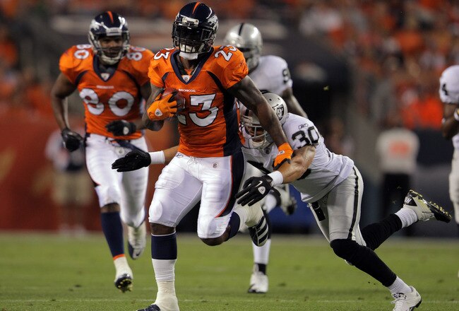 DENVER, CO - SEPTEMBER 12:  Willis McGahee #23 of the Denver Broncos runs the ball as Jerome Boyd #30 of the Oakland Raiders goes for the tackle in the first half at Sports Authority Field at Mile High on September 12, 2011 in Denver, Colorado.  (Photo by Doug Pensinger/Getty Images)