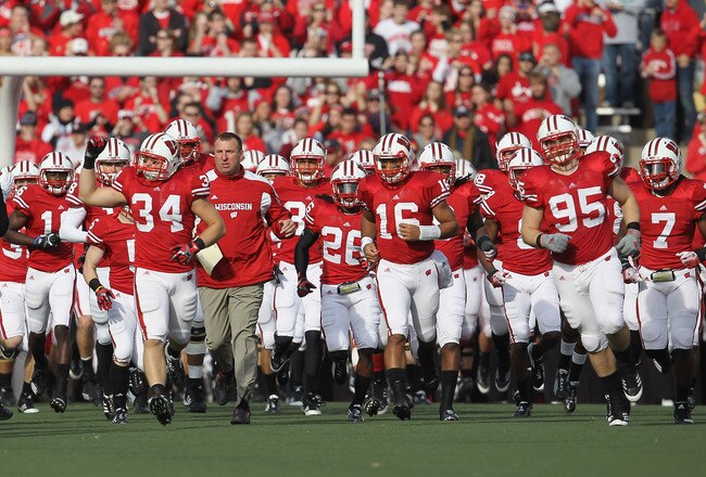 MADISON, WI - NOVEMBER 05: Head coach Bret Bielema of the Wisconsin Badgers (L) runs onto the field with his team before taking on the Purdue Boilermakers at Camp Randall Stadium on November 5, 2011 in Madison Wisconsin. Wisconsin defeated Purdue 62-17. (Photo by Jonathan Daniel/Getty Images)