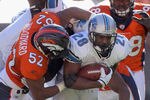 DENVER, CO - OCTOBER 30:  Maurice Morris #28 of the Detroit Lions is tackled by Jason Hunter #52 of the Denver Broncos at Sports Authority Field at Mile High on October 30, 2011 in Denver, Colorado.  (Photo by Doug Pensinger/Getty Images)