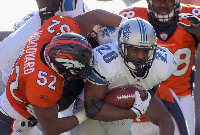 DENVER, CO - OCTOBER 30:  Maurice Morris #28 of the Detroit Lions is tackled by Jason Hunter #52 of the Denver Broncos at Sports Authority Field at Mile High on October 30, 2011 in Denver, Colorado.  (Photo by Doug Pensinger/Getty Images)