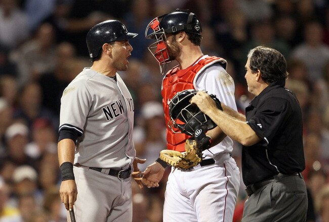BOSTON, MA - AUGUST 30:  Francisco Cervelli #17 of the New York Yankees reacts after he is hit by a pitch as catcher Jarrod Saltalamacchia #39 of the Boston Red Sox and home plate umpire Ed Rapuano try to calm Cervelli down on August 30, 2011 at Fenway Park in Boston, Massachusetts.  (Photo by Elsa/Getty Images)