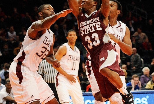 NEW YORK, NY - NOVEMBER 17:  Deville Smith #33 of the Mississippi State Bulldogs drives the ball against Kourtney Roberson #32 of the Texas A&M Aggies during the 2K Sports Classic Benefiting Coaches Vs Cancer at Madison Square Garden on November 17, 2011 in New York City.  (Photo by Patrick McDermott/Getty Images)