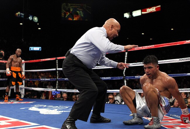 LAS VEGAS, NV - SEPTEMBER 17:  (C) Referee Joe Cortez calls the fight after (L) Victor Ortiz is knocked out by Floyd Mayweather Jr. during their WBC welterweight title fight at the MGM Grand Garden Arena on September 17, 2011 in Las Vegas, Nevada.  (Photo by Al Bello/Getty Images)