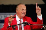 COOPERSTOWN, NY - JULY 31:  Stan Musial gets his harmonica ready to sing 'Take Me Out to the Ball Game' during the Baseball Hall of Fame induction ceremony on July 31, 2005 at the Clark Sports Complex in Cooperstown, New York.  (Photo by Ezra Shaw/Getty Images)