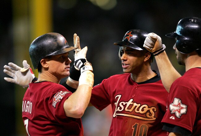 HOUSTON - OCTOBER 10:  Craig Biggio #7 of the Houston Astros is congratulated by Jose Vizcaino #10 and Brad Ausmus #11 after hitting a home run against the Atlanta Braves in the second inning of game four of the National League Divisional Series on October 10, 2004 at Minute Maid Park in Houston, Texas.  (Photo by Jamie Squire/Getty Images)