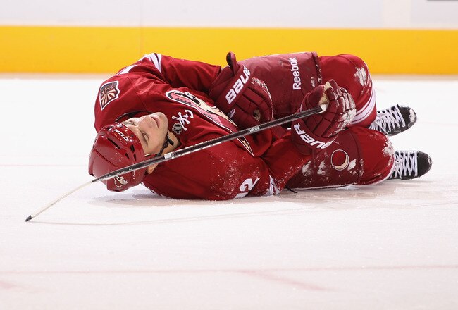 GLENDALE, AZ - OCTOBER 01:  Paul Bissonnette #12 of the Phoenix Coyotes lays on the ice after an injury during the preseason NHL game against the San Jose Sharks at Jobing.com Arena on October 1, 2011 in Glendale, Arizona.  The Coyotes defeated the Sharks 3-1.  (Photo by Christian Petersen/Getty Images)